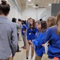 k-12 students looking at a project